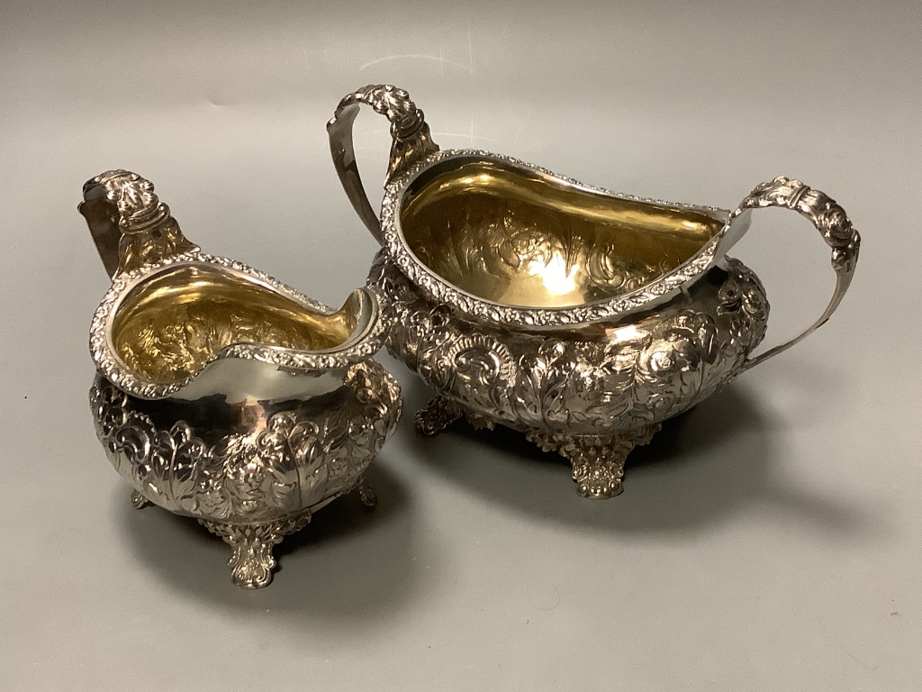 A George the fourth embossed silver cream jug and to handle sugar bowl by Hyam Hyams, London 1824